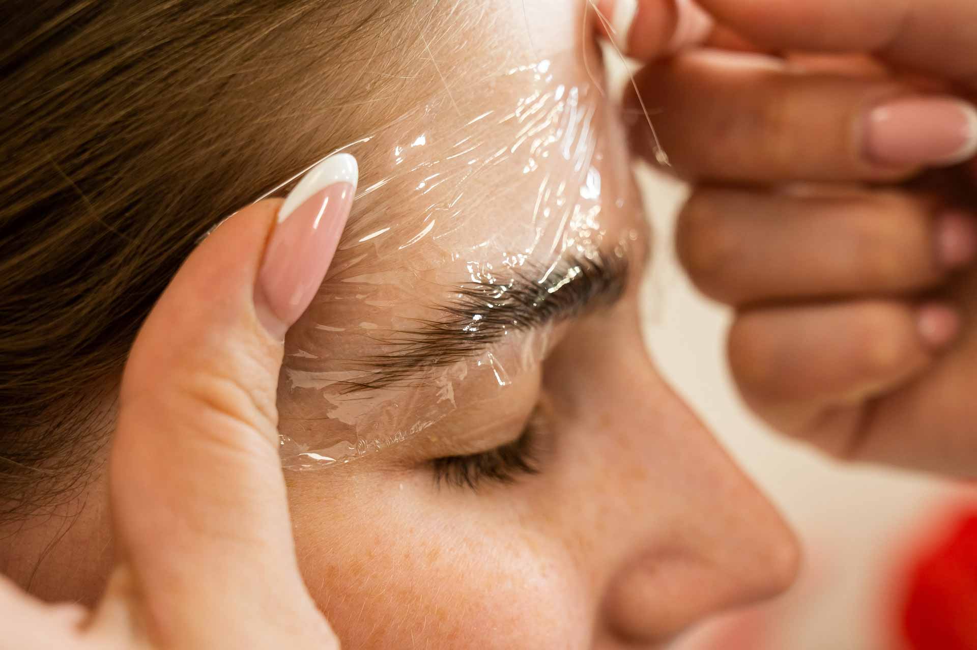 A close up shot of a woman getting an eyebrow lamination 